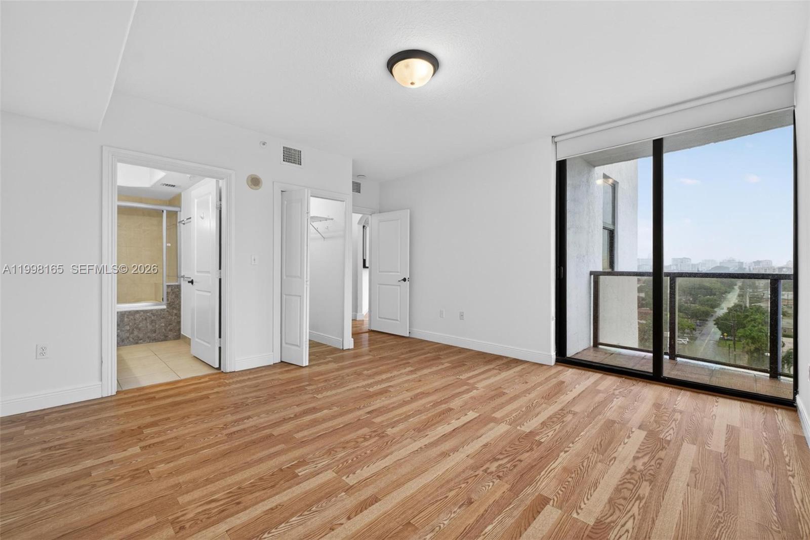 2301 Southwest 27th Avenue, Unit 906 Miami, FL 33145 - Photo 27 of 38 a view of empty room with wooden floor and fan