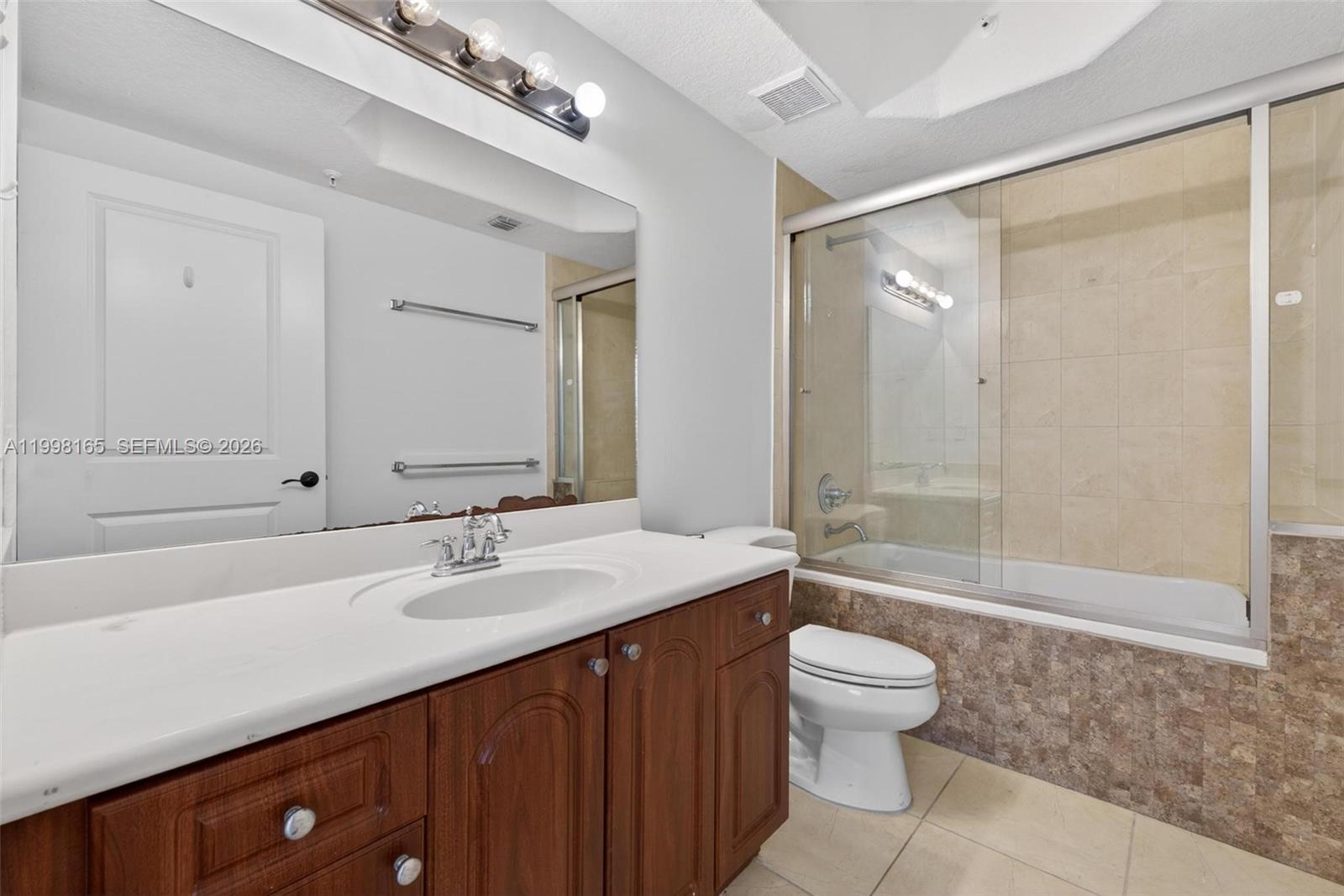 2301 Southwest 27th Avenue, Unit 906 Miami, FL 33145 - Photo 29 of 38 a bathroom with a sink a toilet and shower