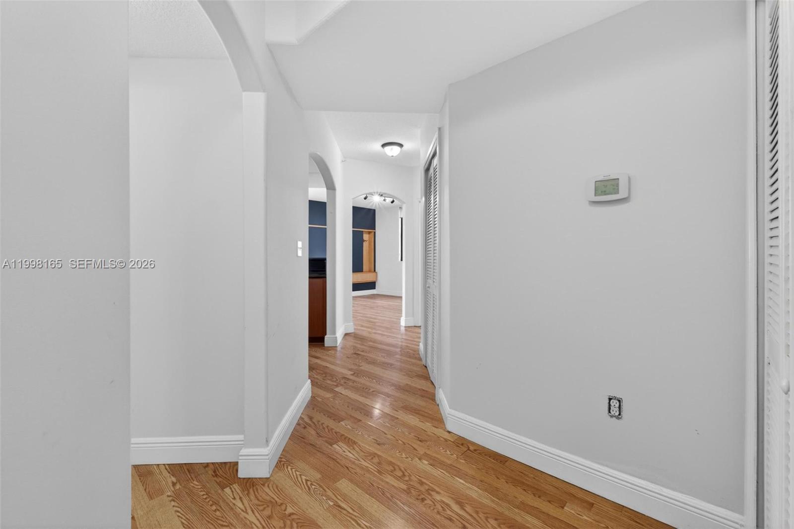 2301 Southwest 27th Avenue, Unit 906 Miami, FL 33145 - Photo 5 of 38 a view of a hallway with wooden floor