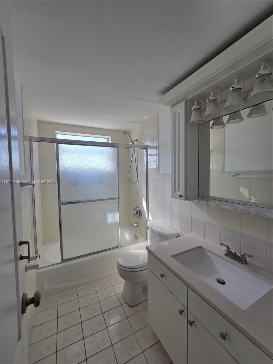 3640 Northwest 9th Street, Unit 407 Miami, FL 33125 - Photo 12 of 24 a bathroom with a sink a toilet and shower