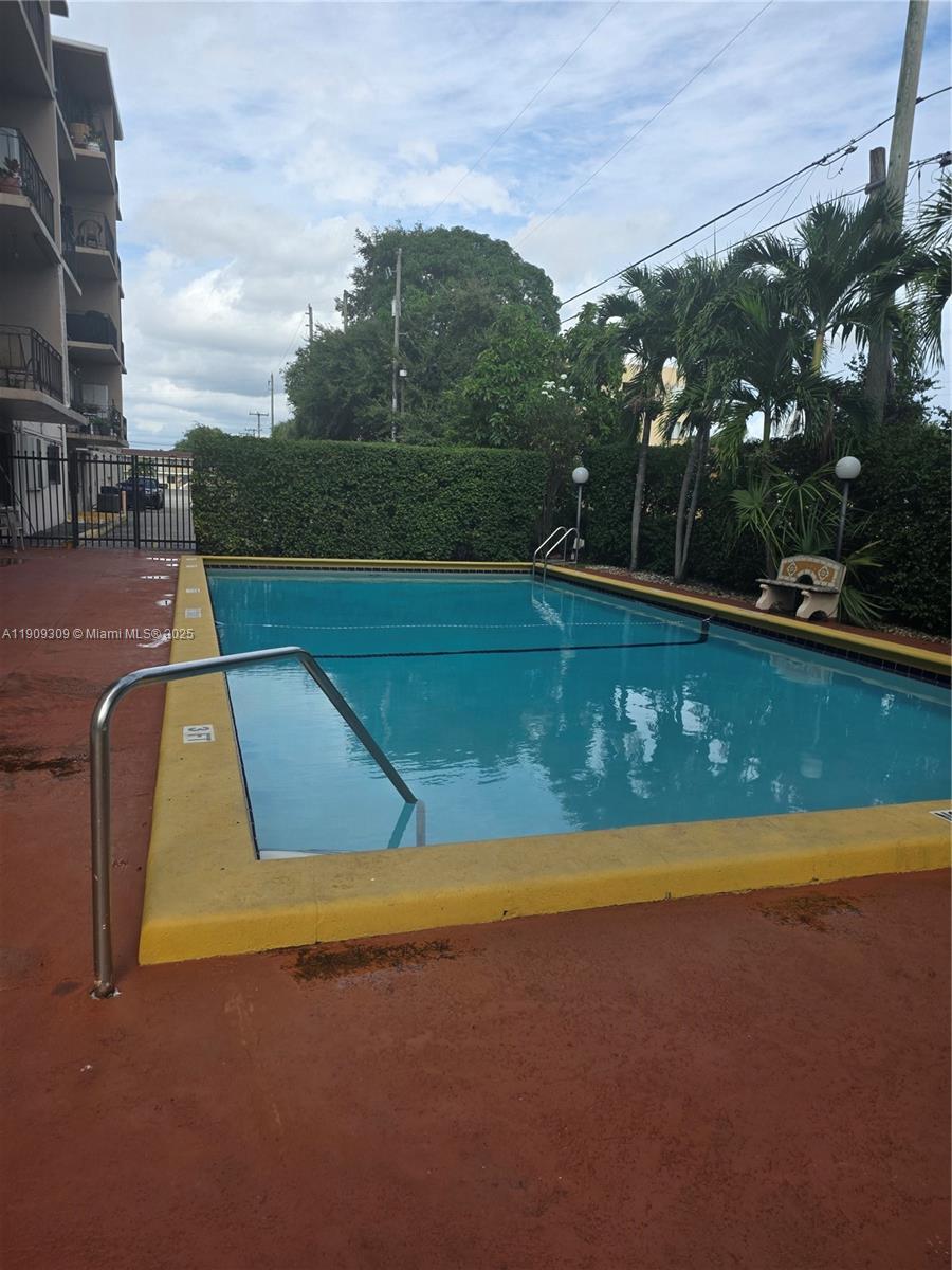 3640 Northwest 9th Street, Unit 407 Miami, FL 33125 - Photo 22 of 24 a view of swimming pool with a yard and outdoor seating