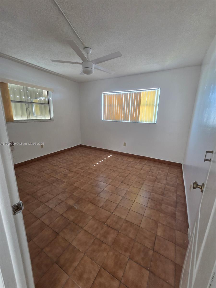 3640 Northwest 9th Street, Unit 407 Miami, FL 33125 - Photo 8 of 24 an empty room with windows