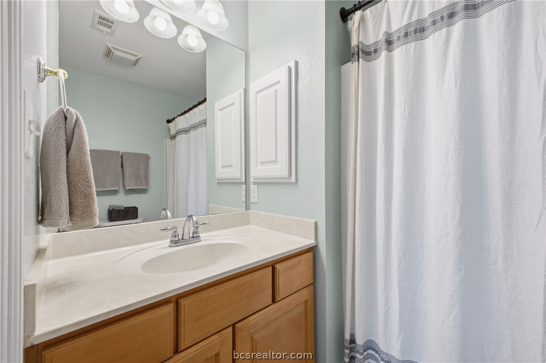 1000 Spring Loop, Unit 2105 College Station, TX 77840 - Photo 12 of 22 a bathroom with a sink and a mirror