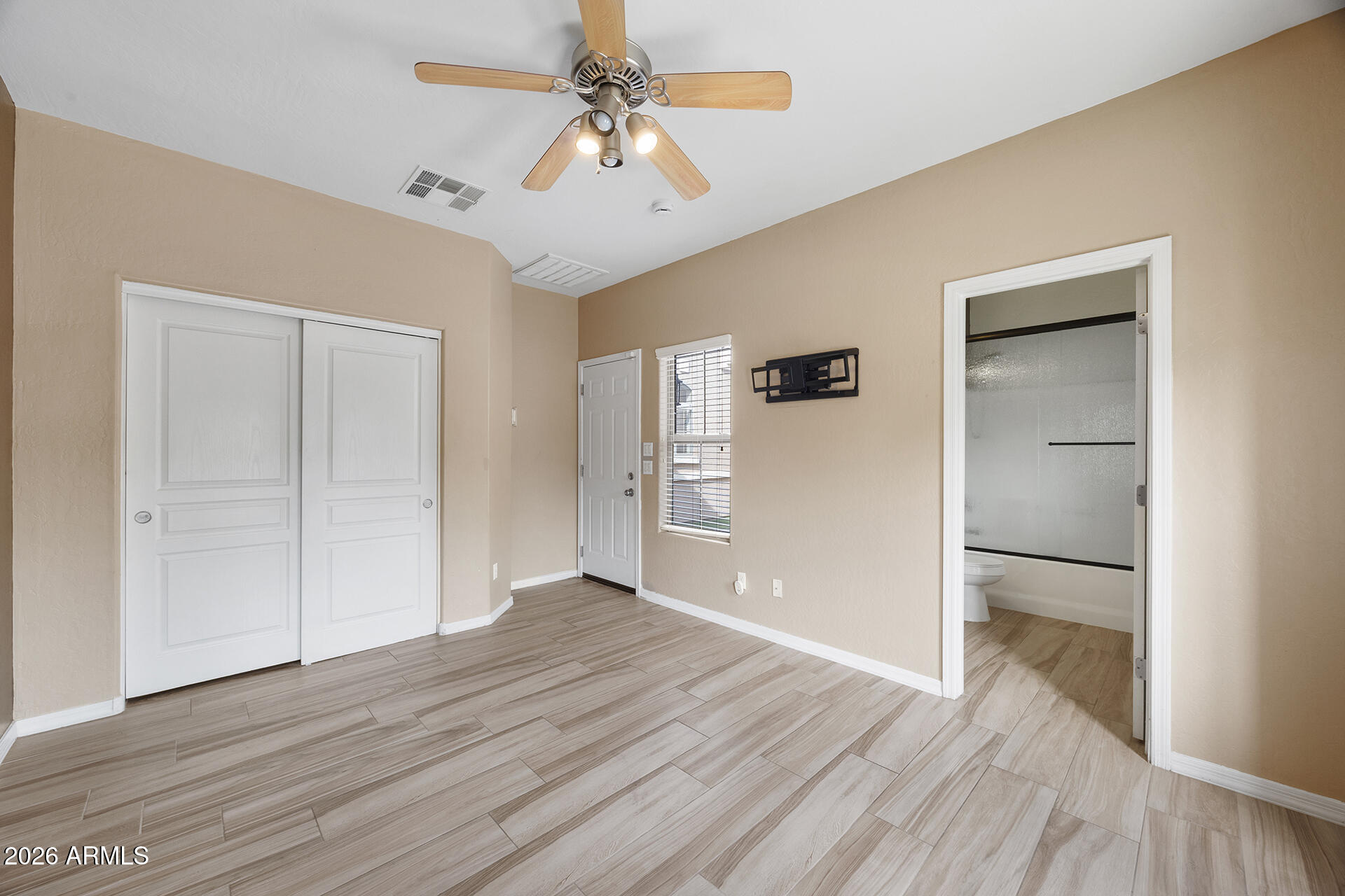 608 West Gary Way Phoenix, AZ 85041 - Photo 13 of 48 a view of empty room with wooden floor