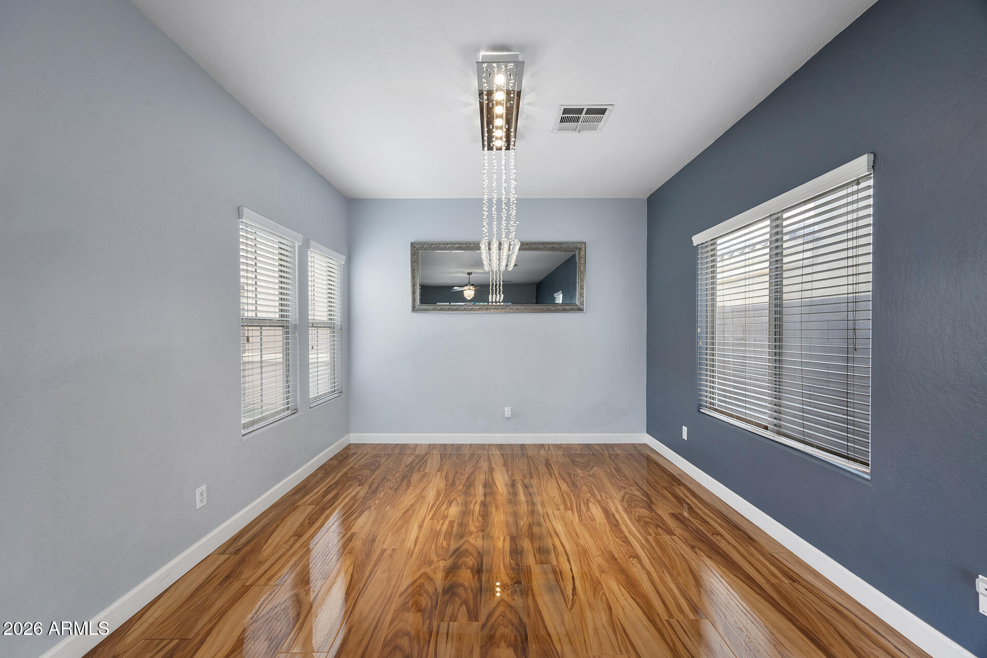 608 West Gary Way Phoenix, AZ 85041 - Photo 15 of 48 a view of empty room with wooden floor and fan