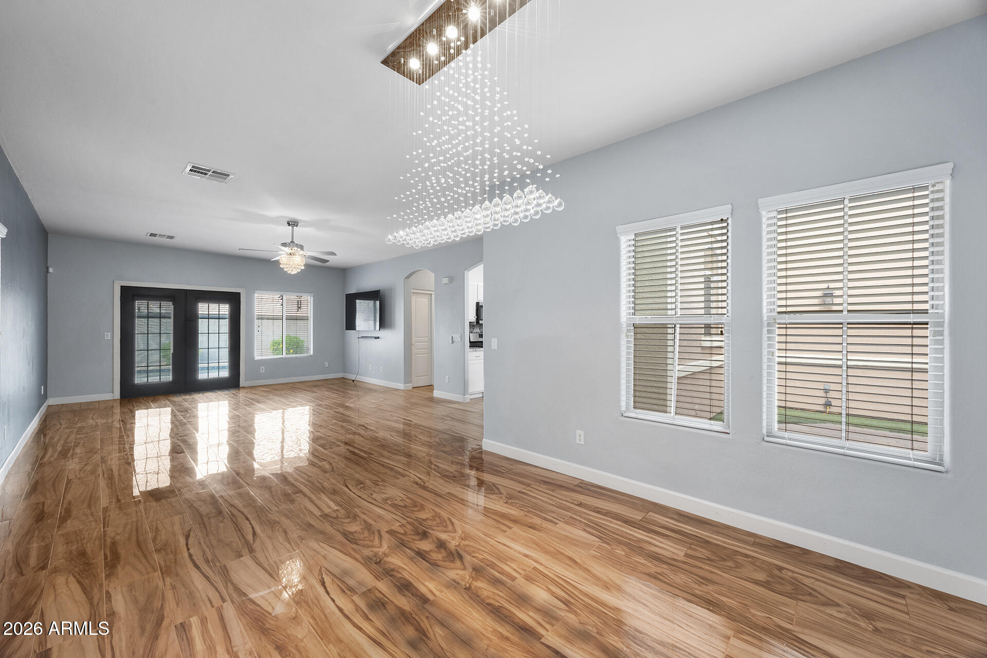 608 West Gary Way Phoenix, AZ 85041 - Photo 16 of 48 a view of an empty room with wooden floor and a window