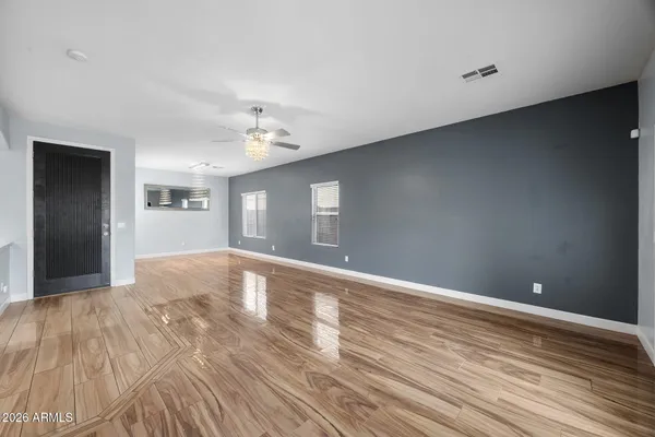 a view of a livingroom with wooden floor and a flat screen tv