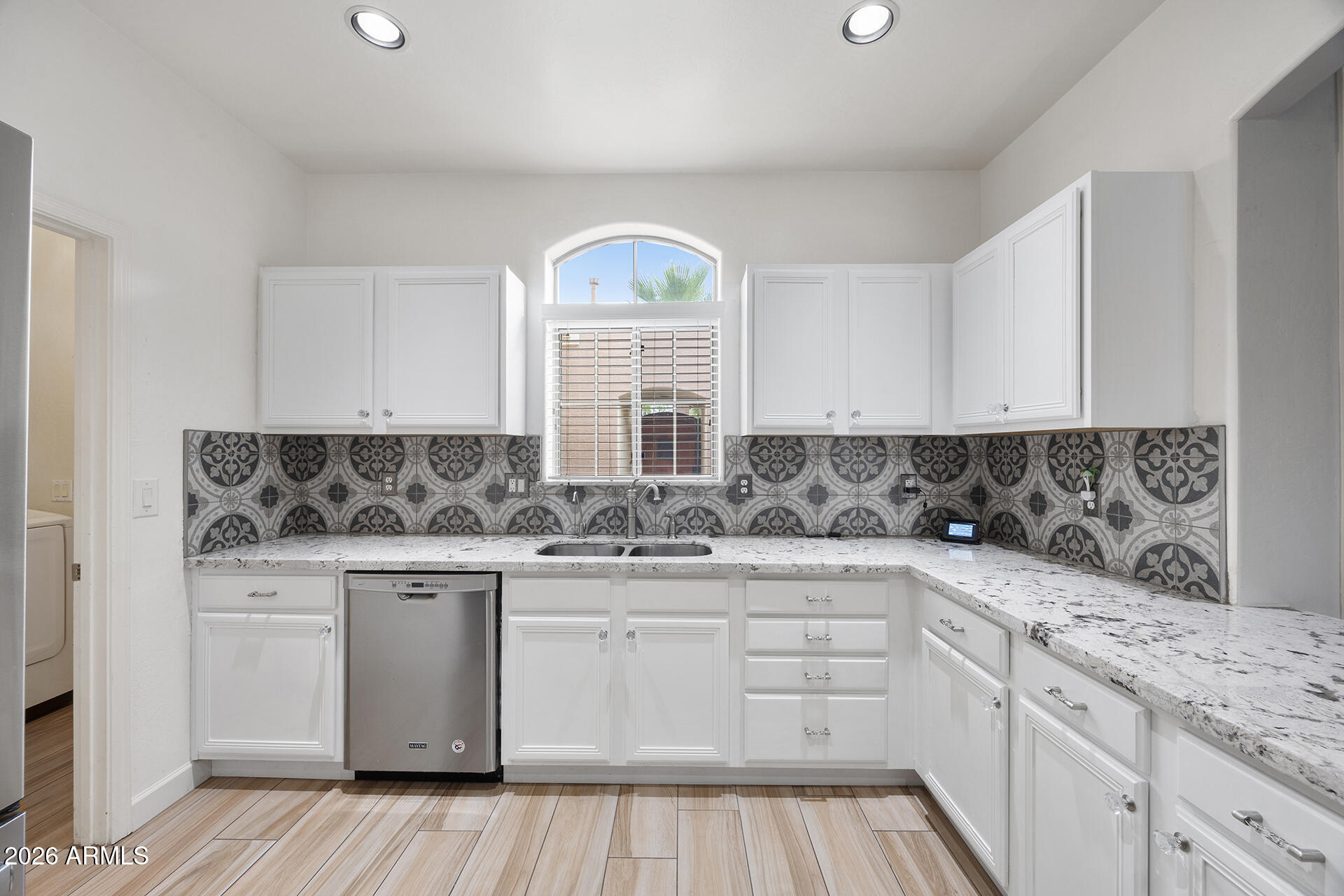 608 West Gary Way Phoenix, AZ 85041 - Photo 21 of 48 a kitchen with stainless steel appliances granite countertop a sink and cabinets with wooden floor