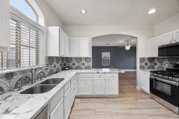 a kitchen with a sink cabinets and window