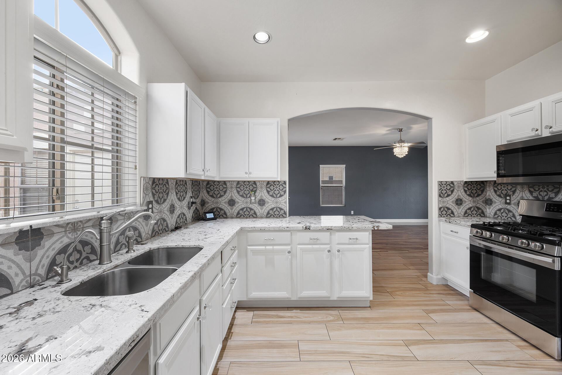 608 West Gary Way Phoenix, AZ 85041 - Photo 23 of 48 a kitchen with a sink stove top oven and cabinets