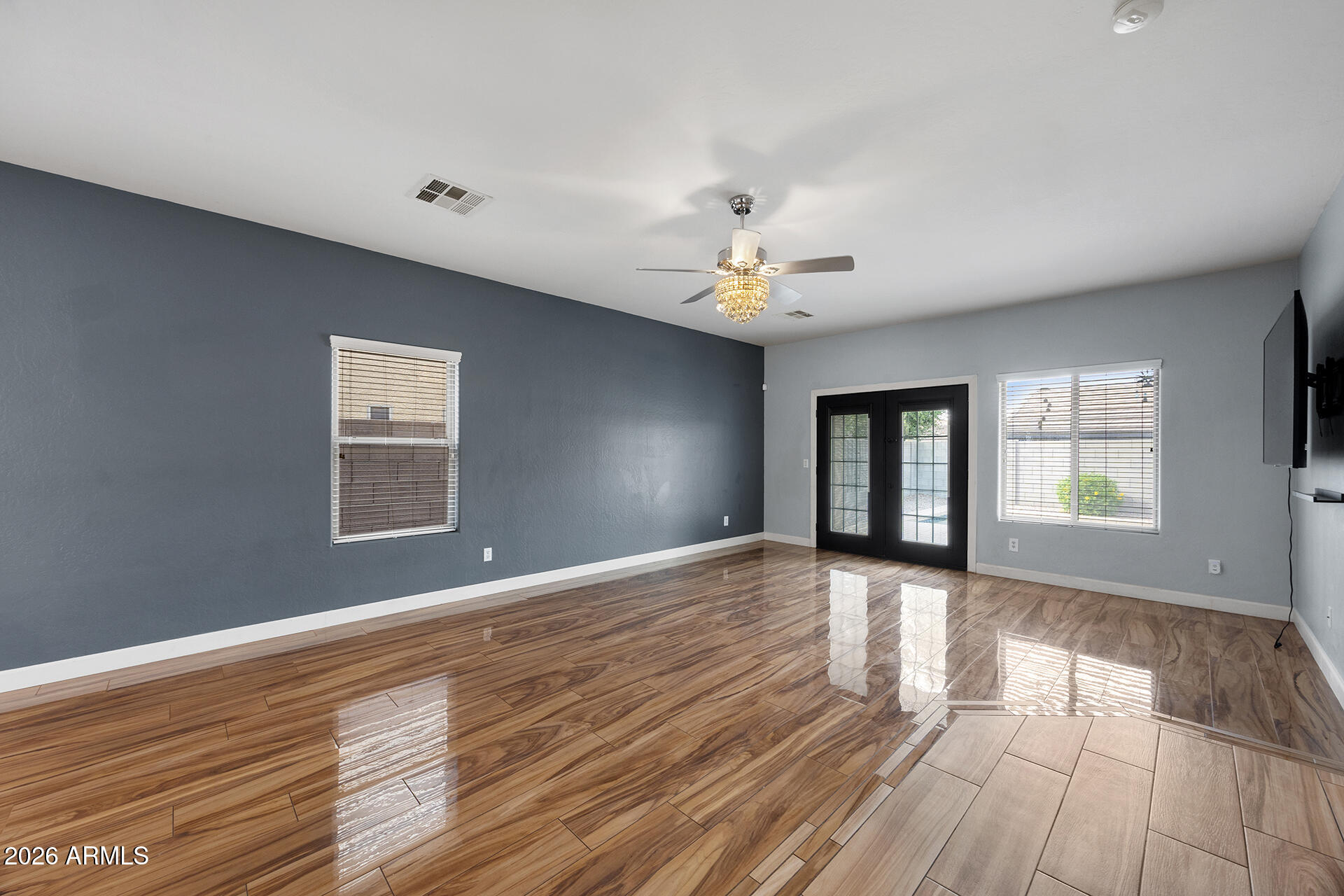 608 West Gary Way Phoenix, AZ 85041 - Photo 2 of 48 a view of an empty room with a window and wooden floor