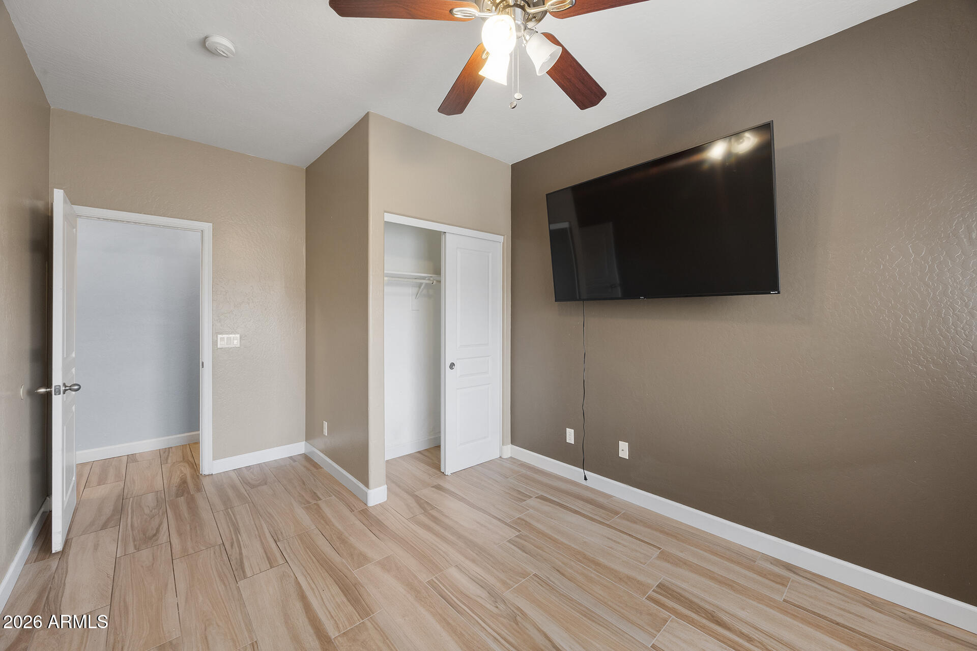608 West Gary Way Phoenix, AZ 85041 - Photo 30 of 48 a view of a livingroom with wooden floor and a ceiling fan