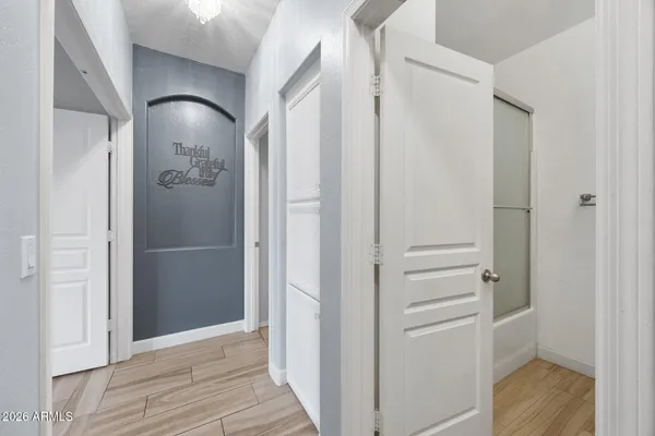 a view of a livingroom with wooden floor and a ceiling fan