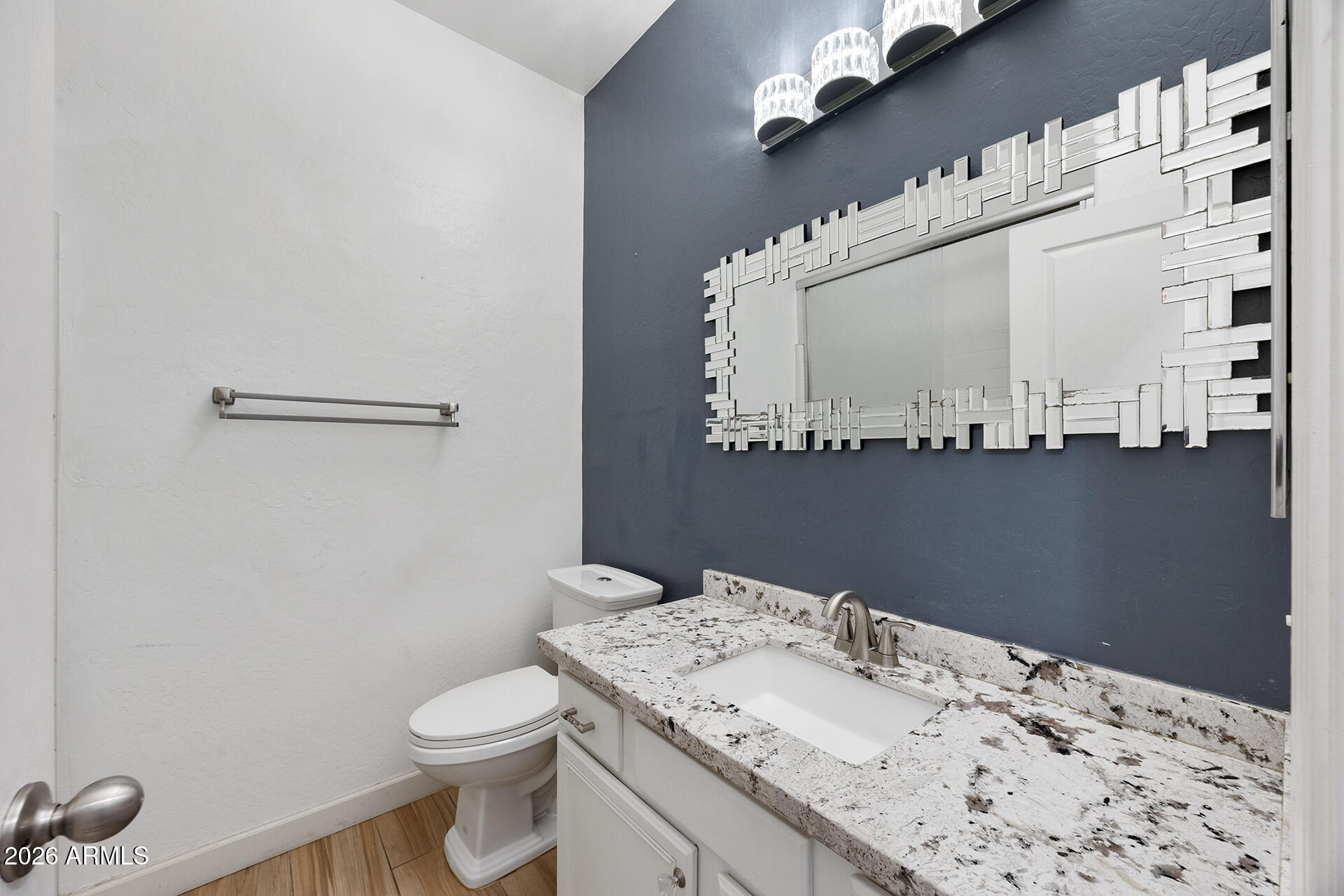 608 West Gary Way Phoenix, AZ 85041 - Photo 32 of 48 a bathroom with a sink a toilet and mirror
