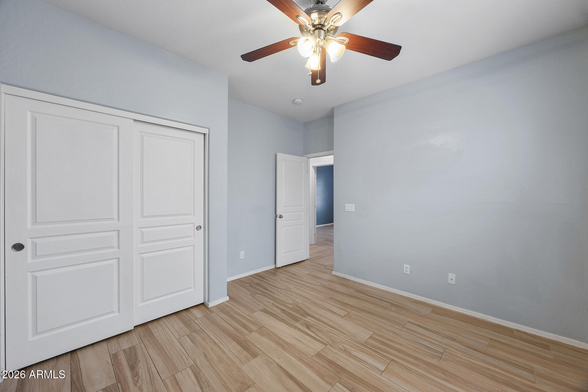 608 West Gary Way Phoenix, AZ 85041 - Photo 35 of 48 a view of an empty room with wooden floor