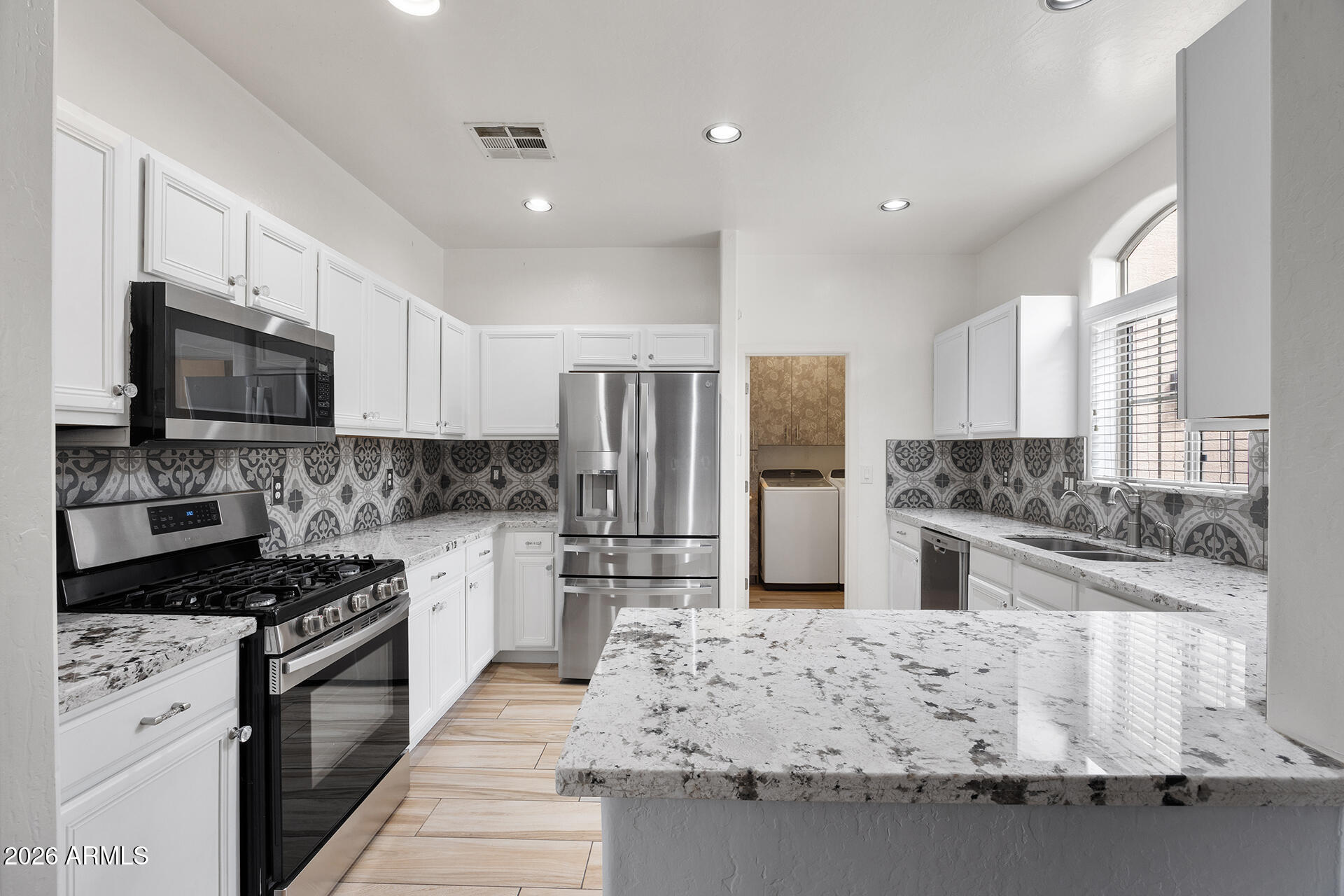 608 West Gary Way Phoenix, AZ 85041 - Photo 3 of 48 a kitchen with stainless steel appliances kitchen island granite countertop a stove sink and refrigerator