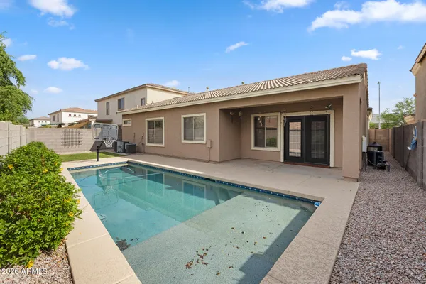 a view of a house with pool plants and large tree