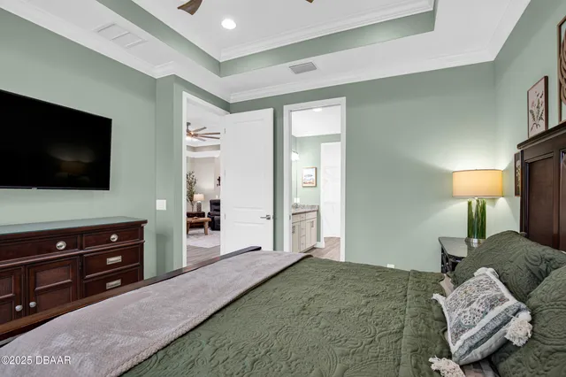 a bedroom with a bed and flat screen tv