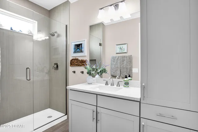 a bathroom with a sink a shower and a mirror