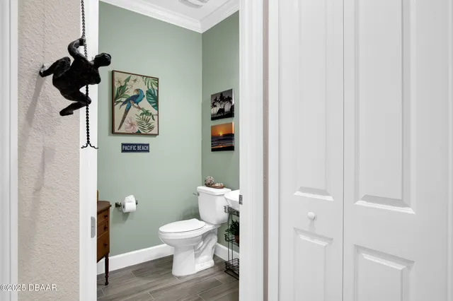 a white toilet sitting next to a bathroom sink and vanity