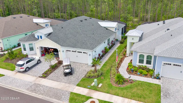 an aerial view of a house with garden space and street view
