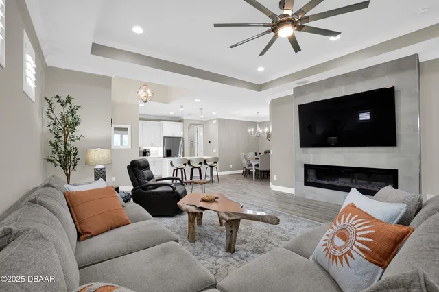 a living room with furniture a fireplace and a flat screen tv