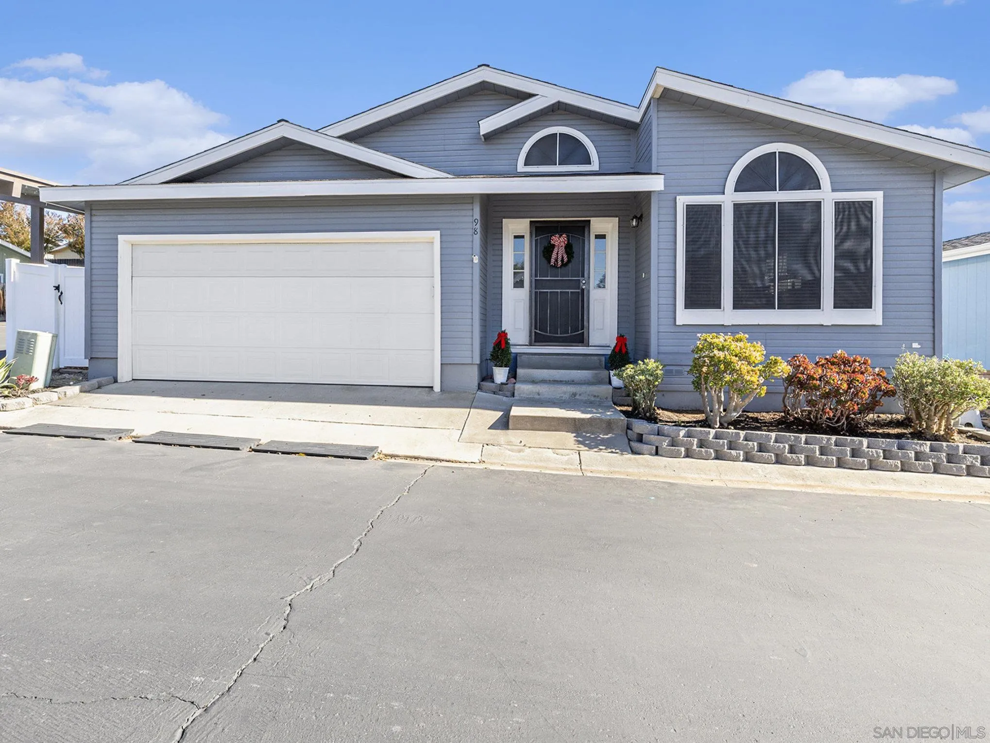a view of a brick house with potted plants