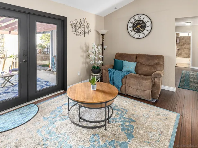 a living room with furniture a clock and a window