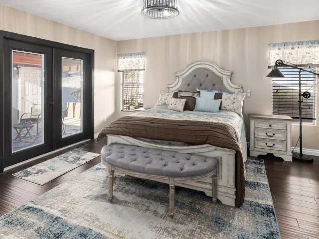 a bed sitting in a bedroom next to a window