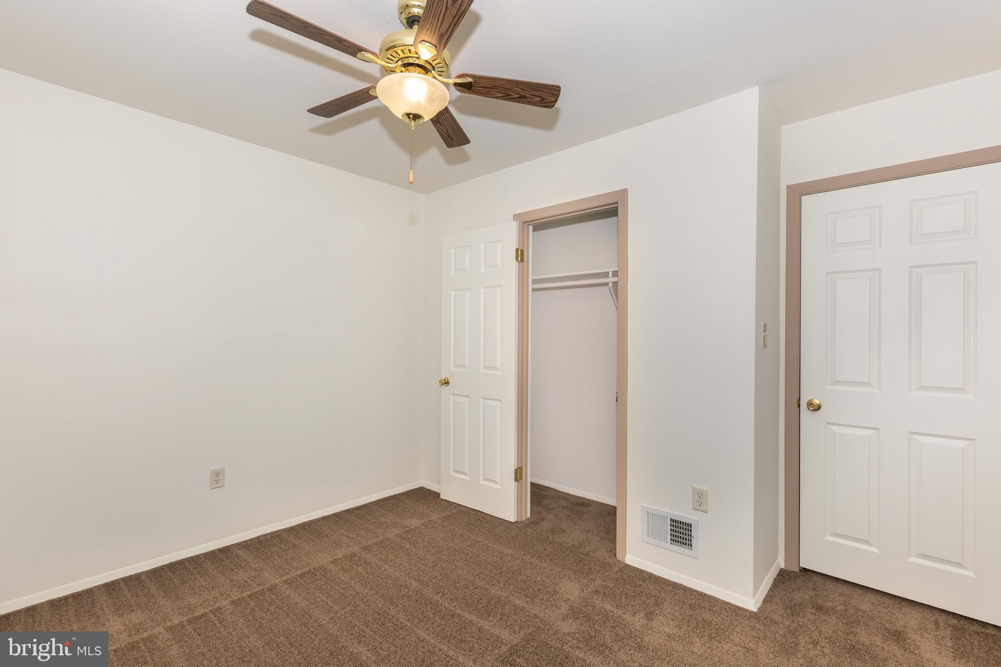 8240 WB&A Road Severn, MD 21144 - Photo 11 of 43 an empty room with a ceiling fan and a fan