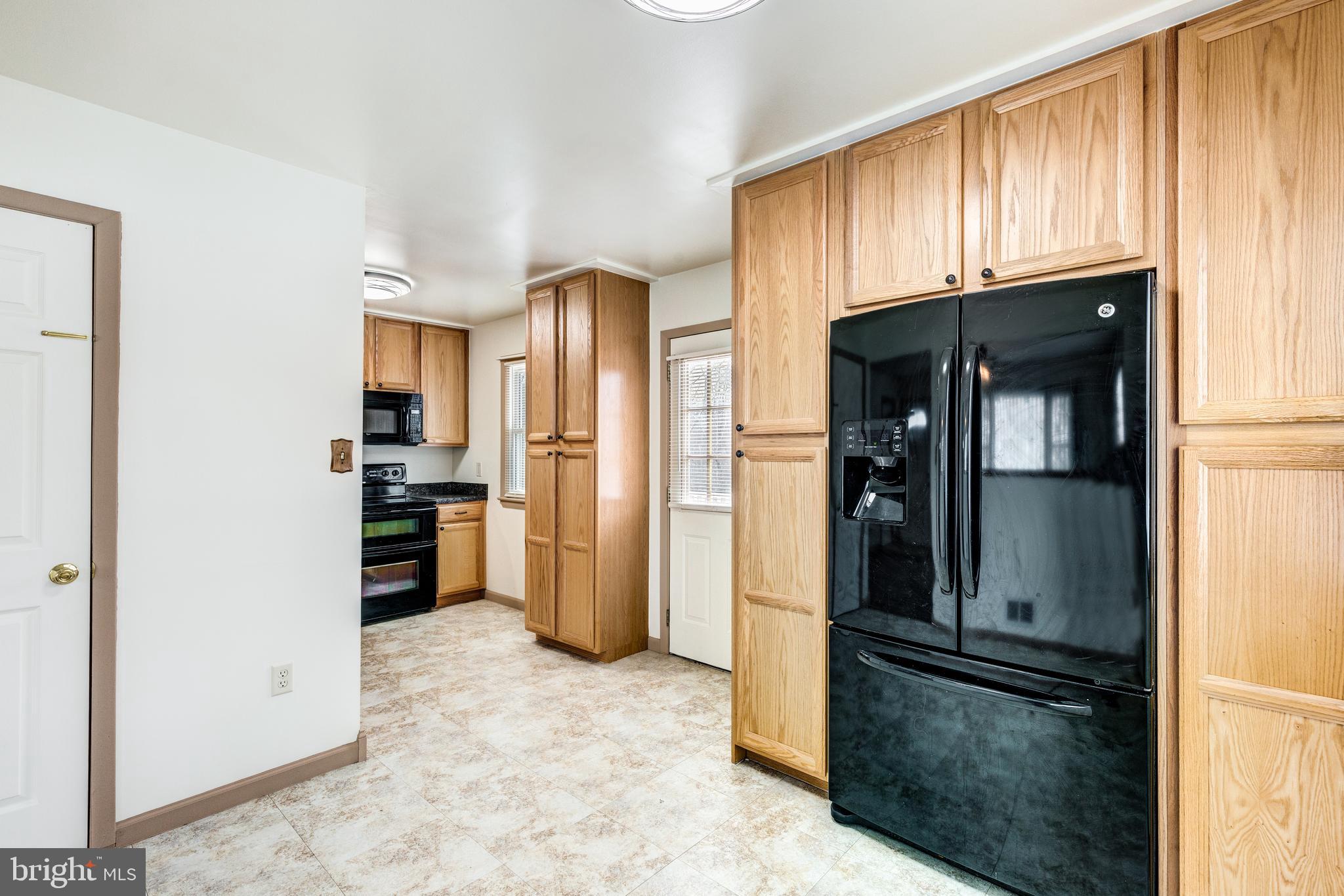 8240 WB&A Road Severn, MD 21144 - Photo 20 of 43 a kitchen with stainless steel appliances granite countertop a refrigerator and a stove