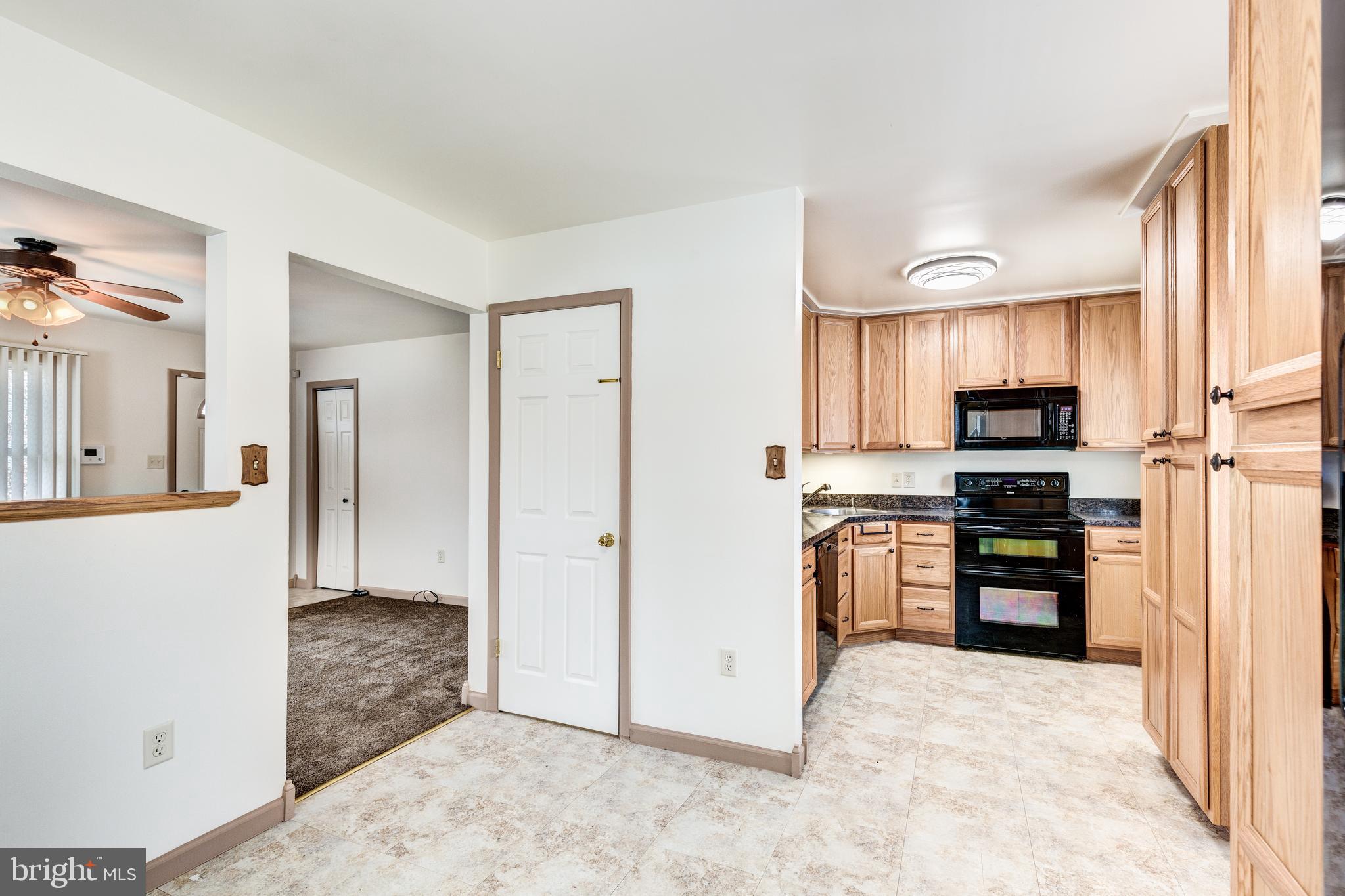 8240 WB&A Road Severn, MD 21144 - Photo 21 of 43 a kitchen with stainless steel appliances granite countertop a refrigerator and a stove top oven