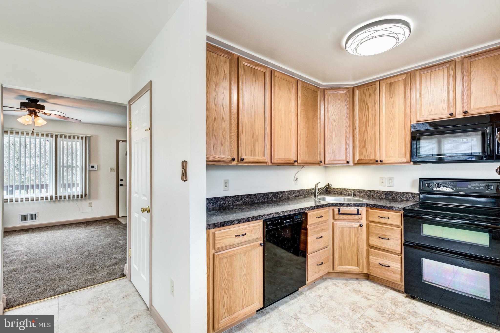 8240 WB&A Road Severn, MD 21144 - Photo 23 of 43 a kitchen with stainless steel appliances granite countertop a stove a sink and a microwave