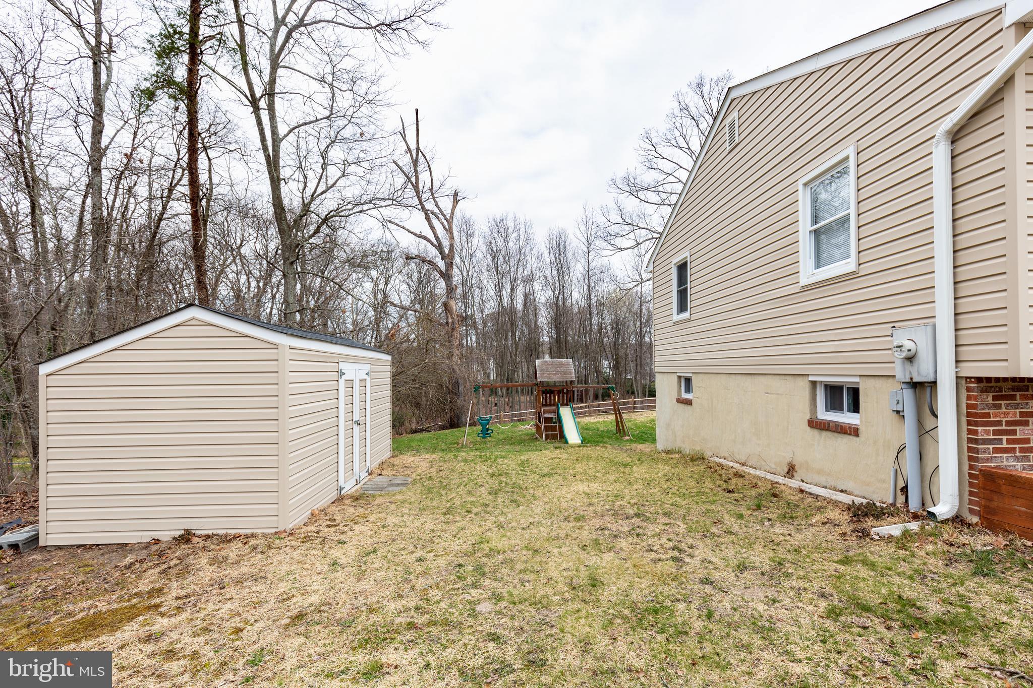8240 WB&A Road Severn, MD 21144 - Photo 36 of 43 a backyard of a house with white fence and trees