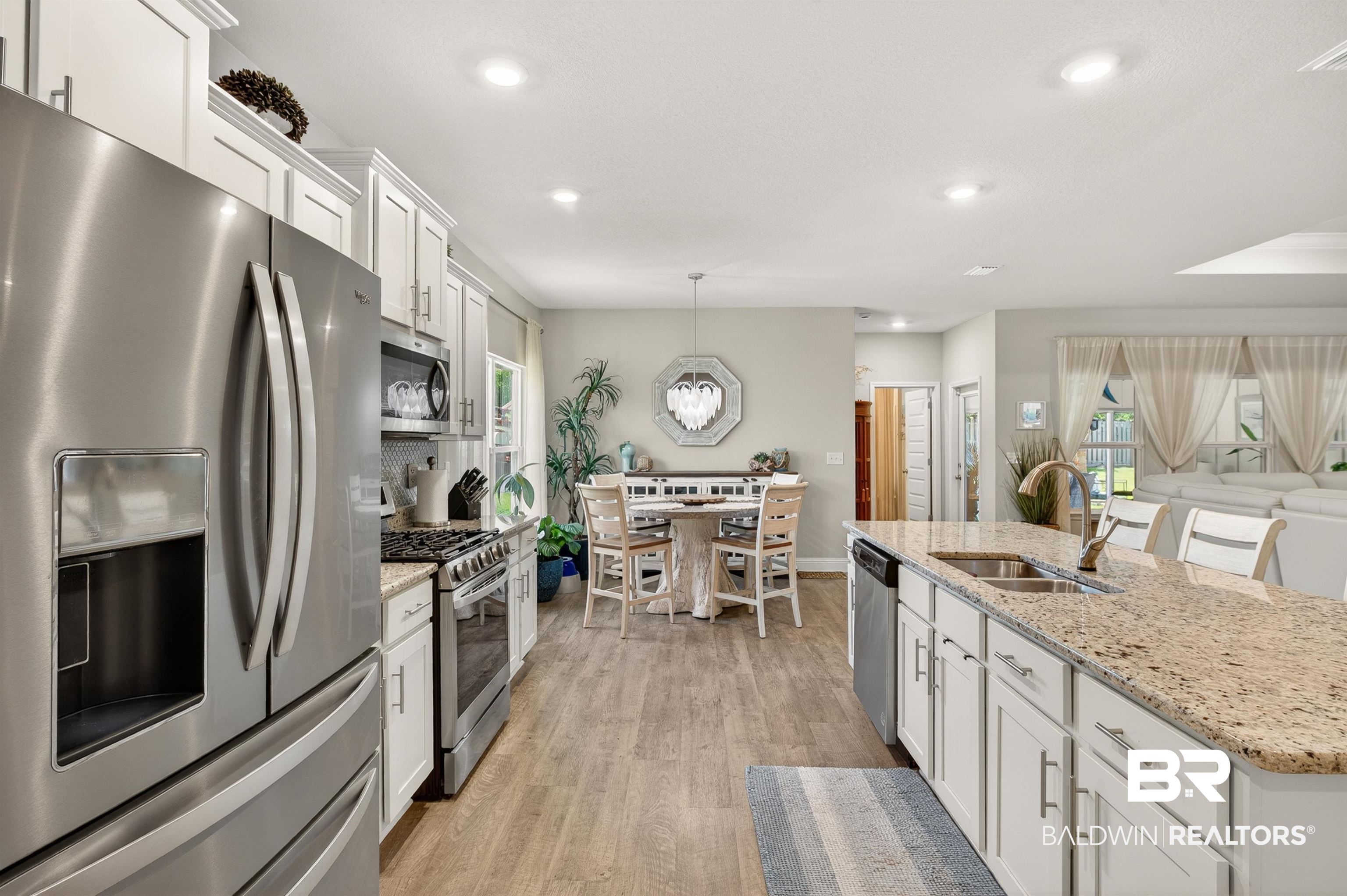 8735 Bronze Lane Foley, AL 36535 - Photo 10 of 58 Kitchen featuring stainless steel appliances, light wood-finish flooring, white cabinetry, granite countertops, and recessed lighting
