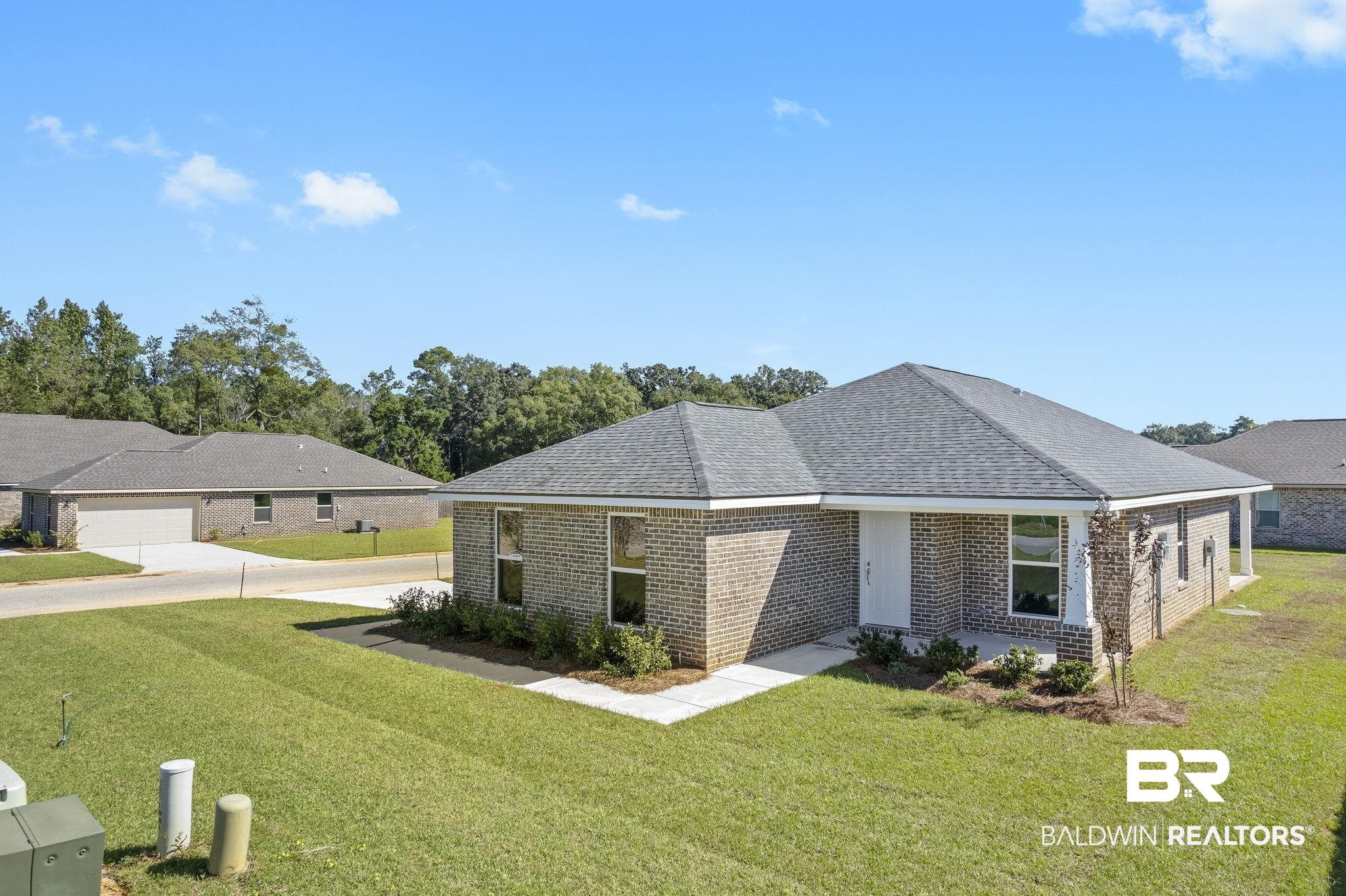 16014 Alabama Avenue Silverhill, AL 36576 - Photo 43 of 50 View of front of house featuring a garage and a front lawn