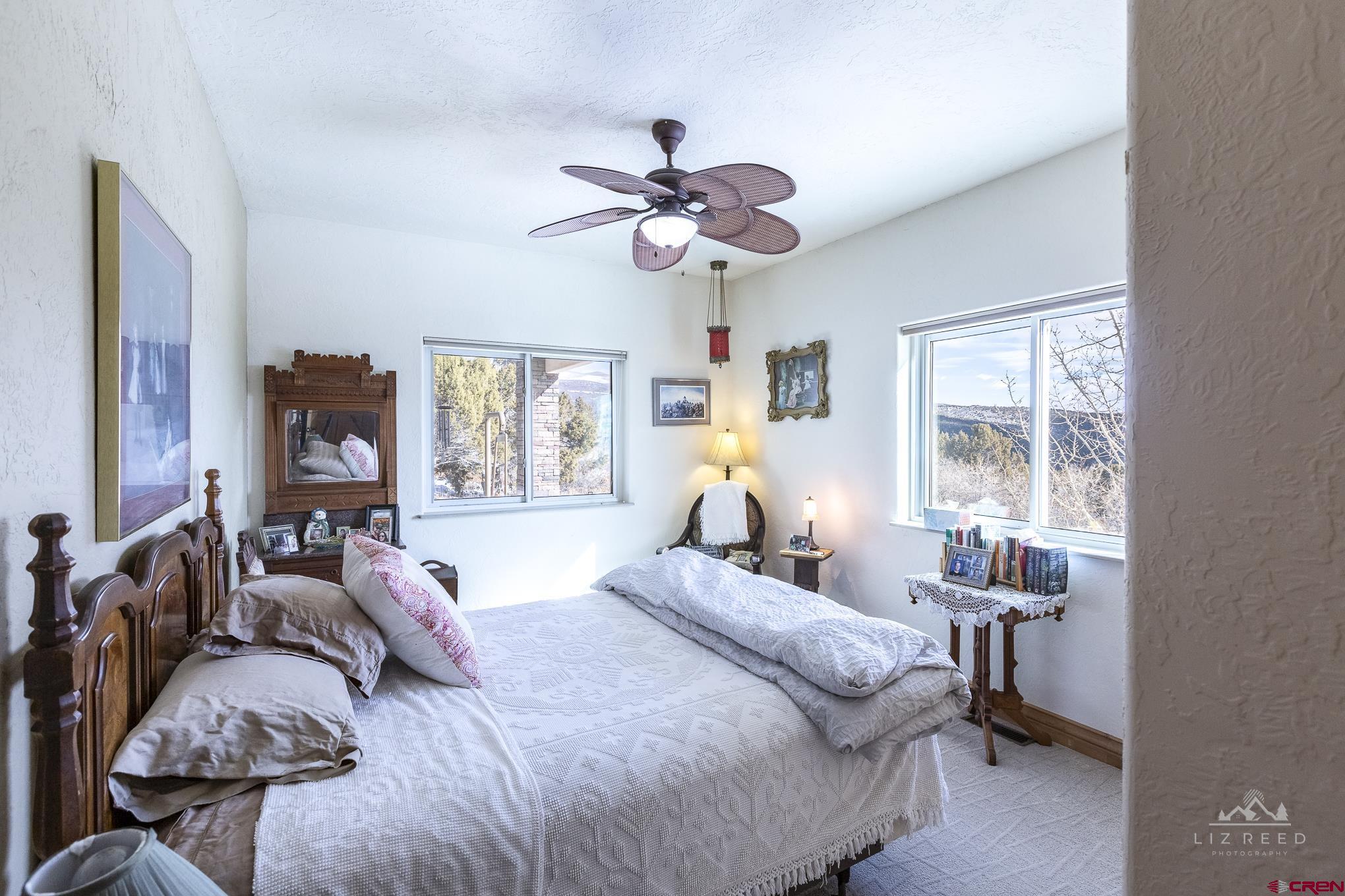 21602 Standingbear Road Cedaredge, CO 81413 - Photo 13 of 35 a bedroom with bed and a window
