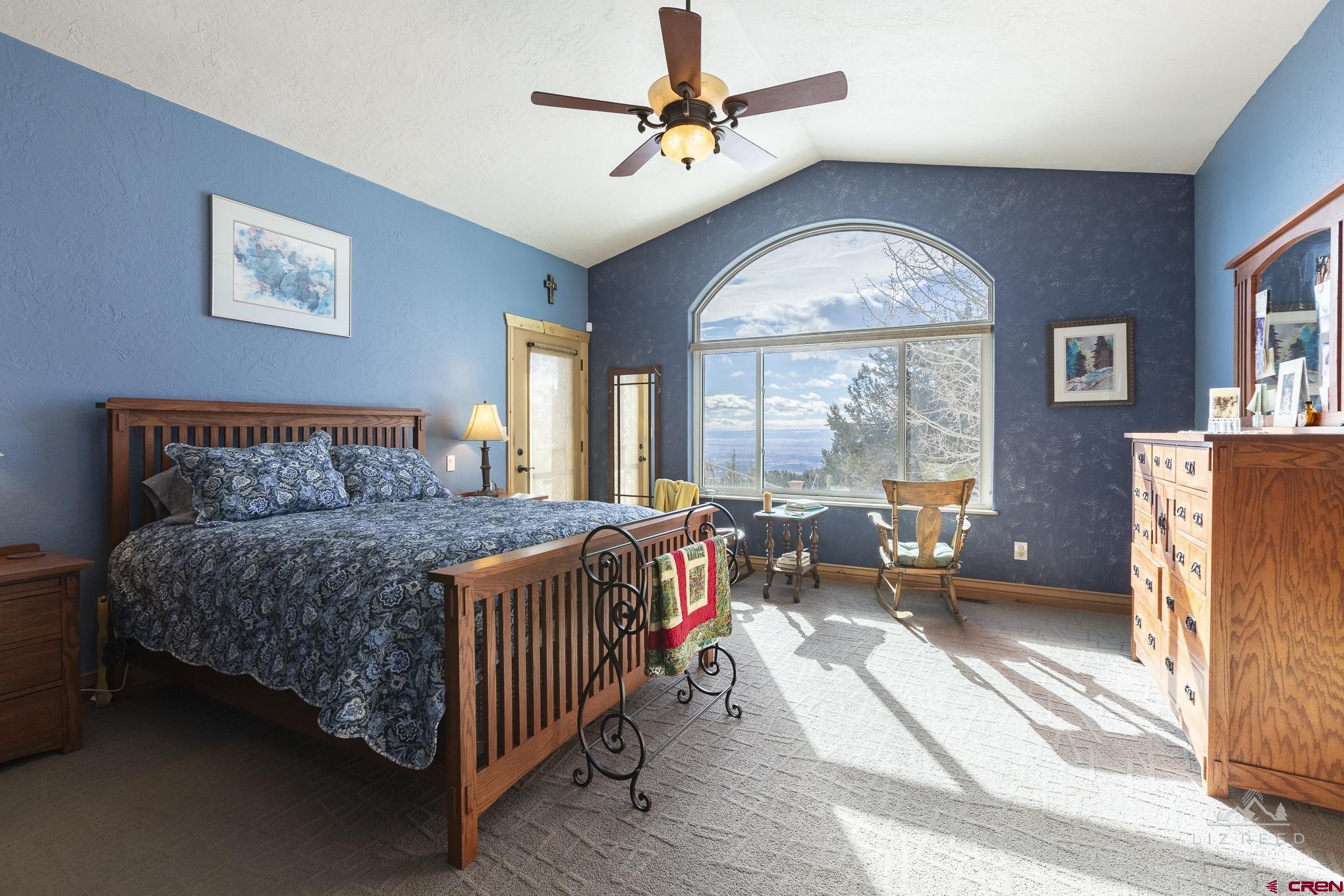 21602 Standingbear Road Cedaredge, CO 81413 - Photo 21 of 35 a bedroom with a bed and a large window