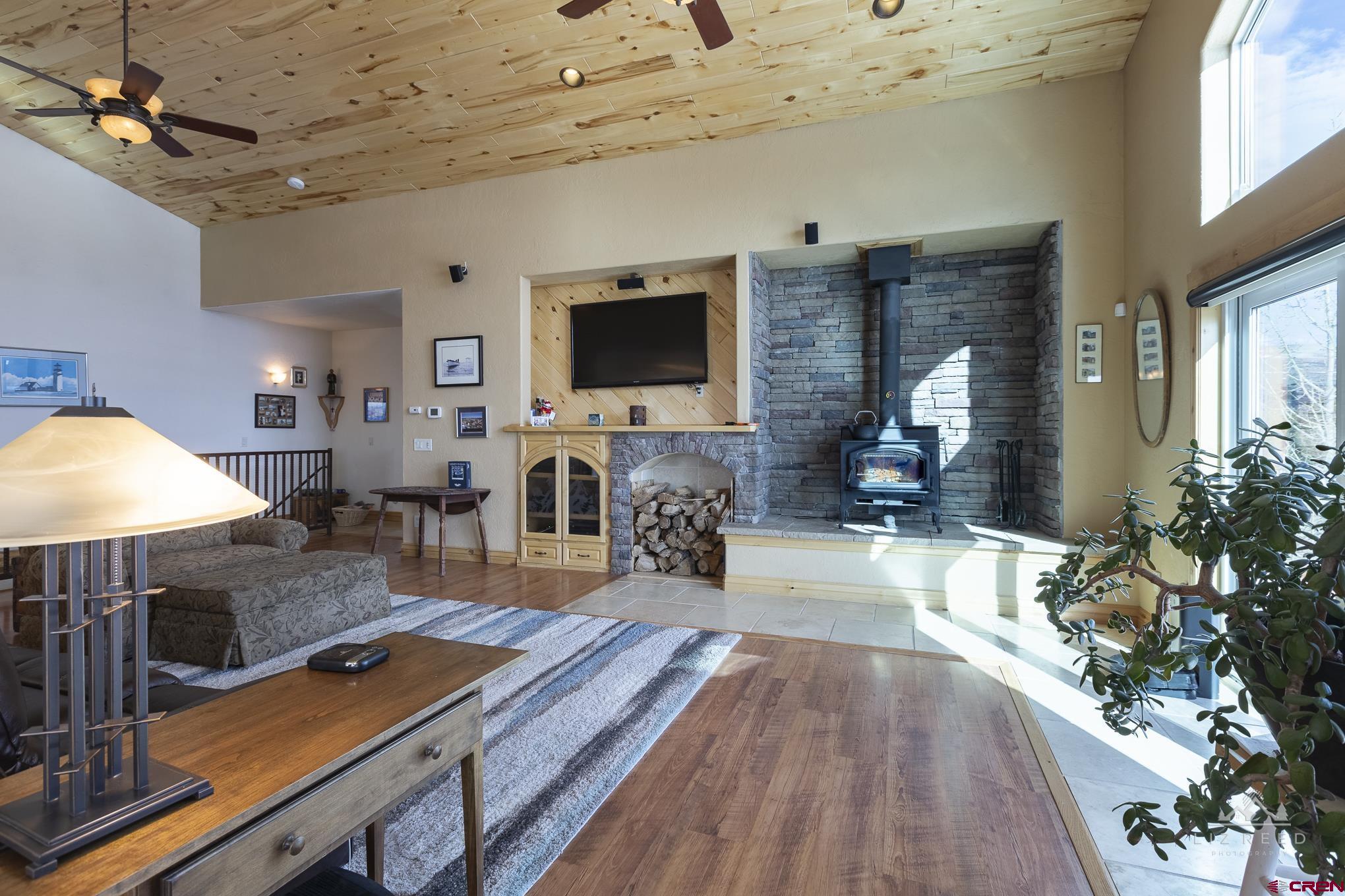 21602 Standingbear Road Cedaredge, CO 81413 - Photo 27 of 35 a living room with furniture and a flat screen tv