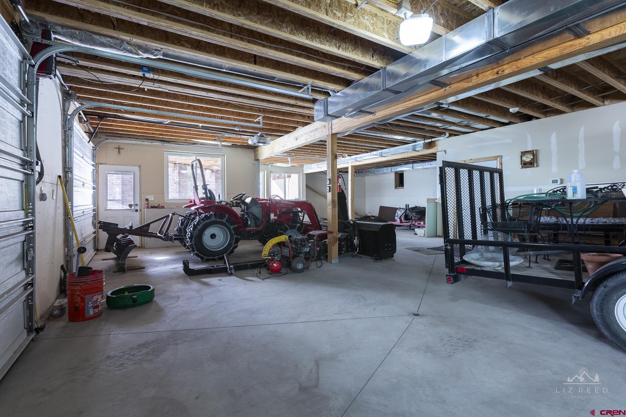 21602 Standingbear Road Cedaredge, CO 81413 - Photo 30 of 35 a view of a garage with parked cars