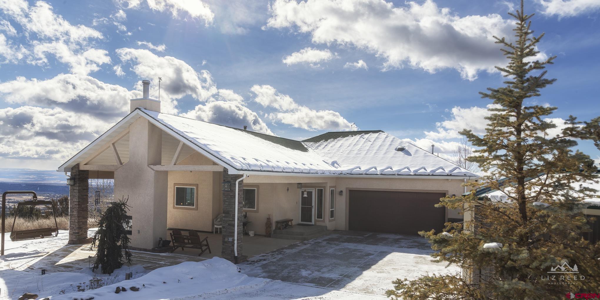 21602 Standingbear Road Cedaredge, CO 81413 - Photo 5 of 35 a front view of a house with a yard