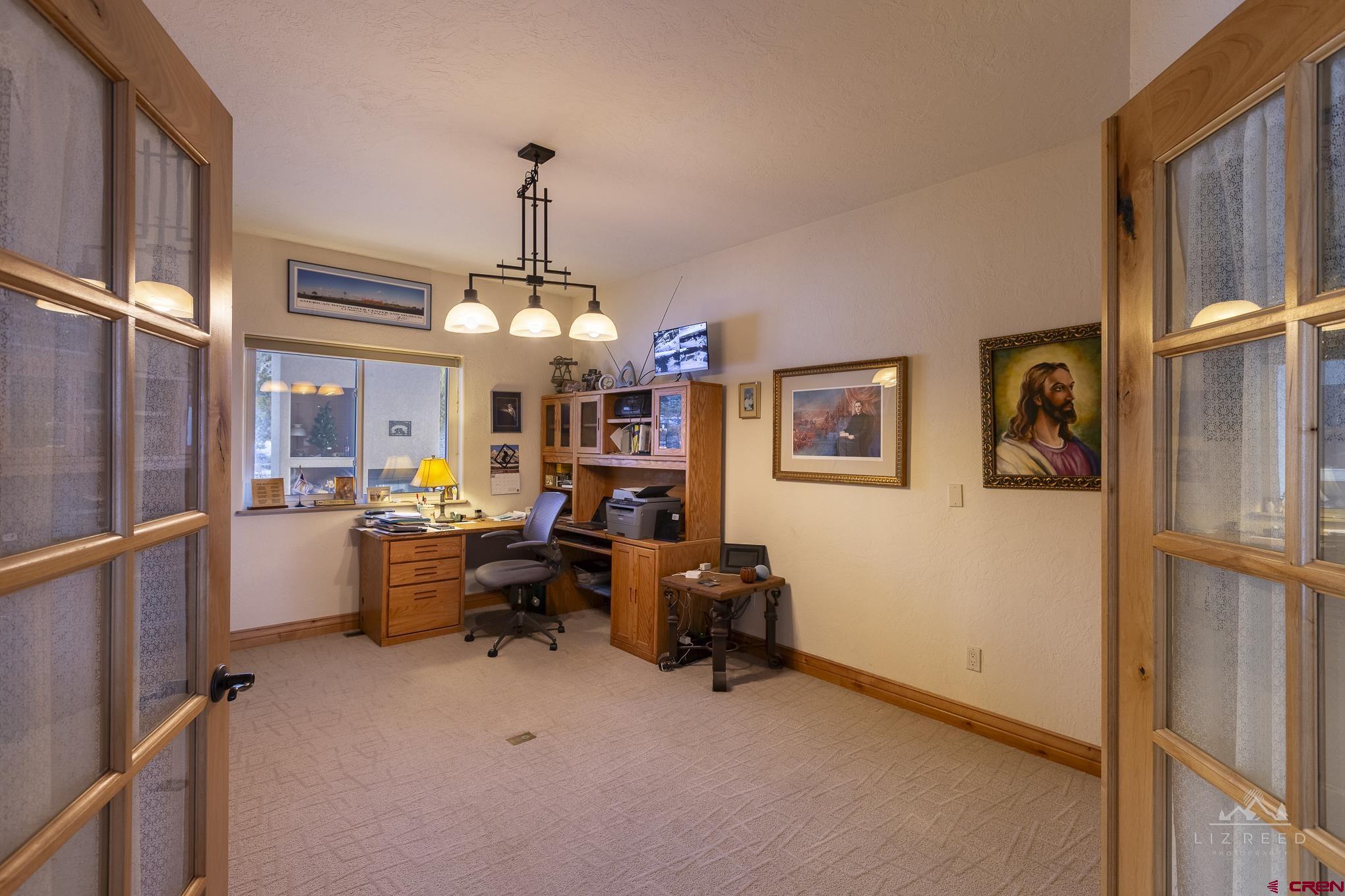 21602 Standingbear Road Cedaredge, CO 81413 - Photo 9 of 35 a view of a livingroom with workspace and a window