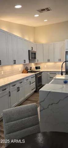 a bedroom with a bed window and a television