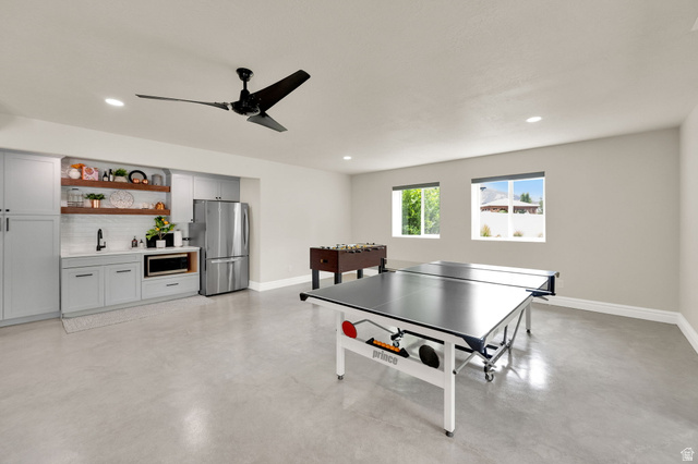 1132 South 1300th Street West Mapleton, UT 84664 - Photo 31 of 52 Spacious entertainment area featuring light gray walls, recessed lighting, and a contemporary ceiling fan