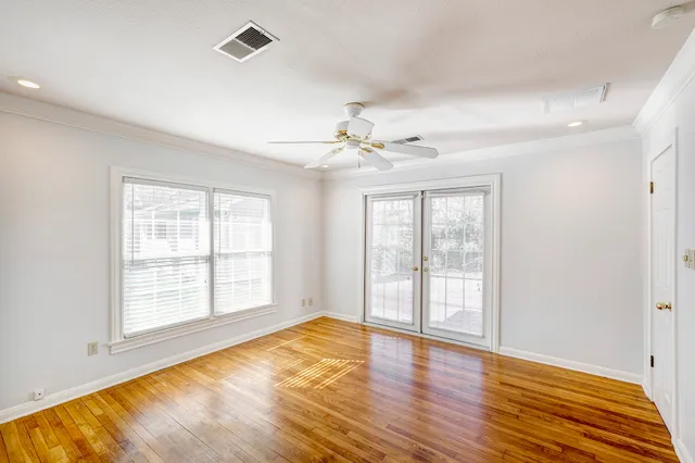 wooden floor in an empty room with a window