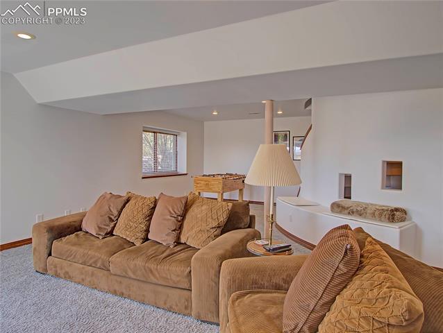 1165 Bowstring Road Monument, CO 80132 - Photo 22 of 27 Second family room in walk out basement includes fun kids play space under stairs and built in seating and storage.