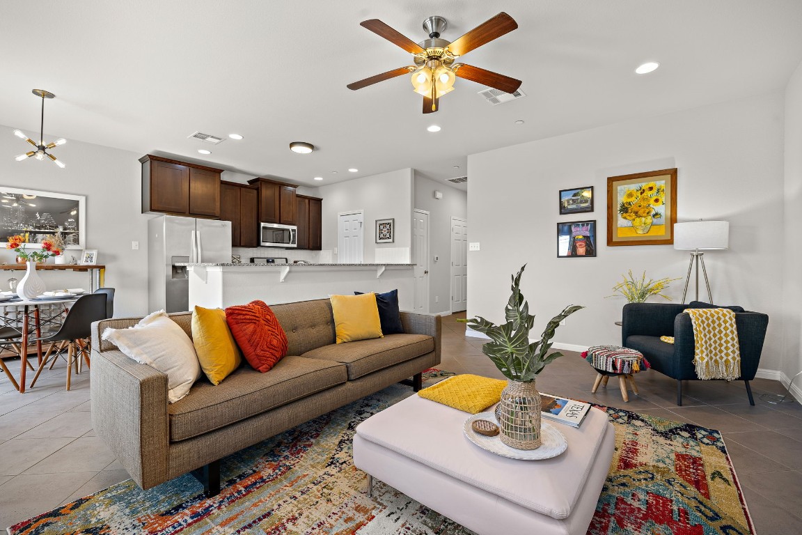1302 Catalan Road, Unit 1002 Austin, TX 78748 - Photo 1 of 1 a living room with furniture kitchen view and a chandelier