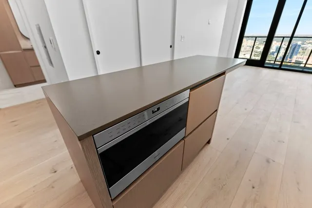 a view of an empty room and wooden floor