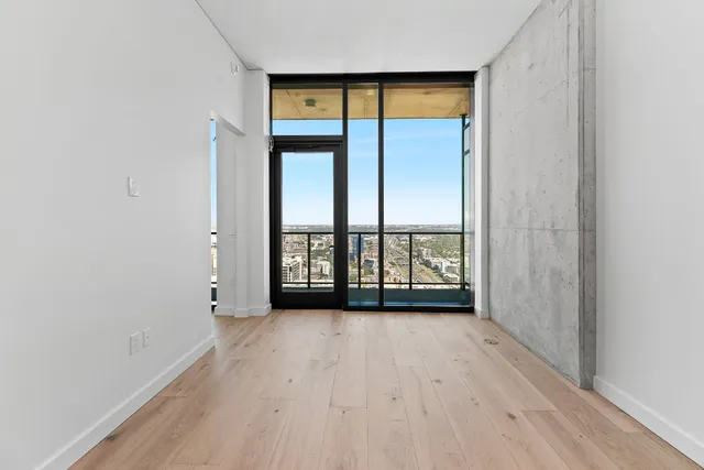 wooden floor in an empty room with a window