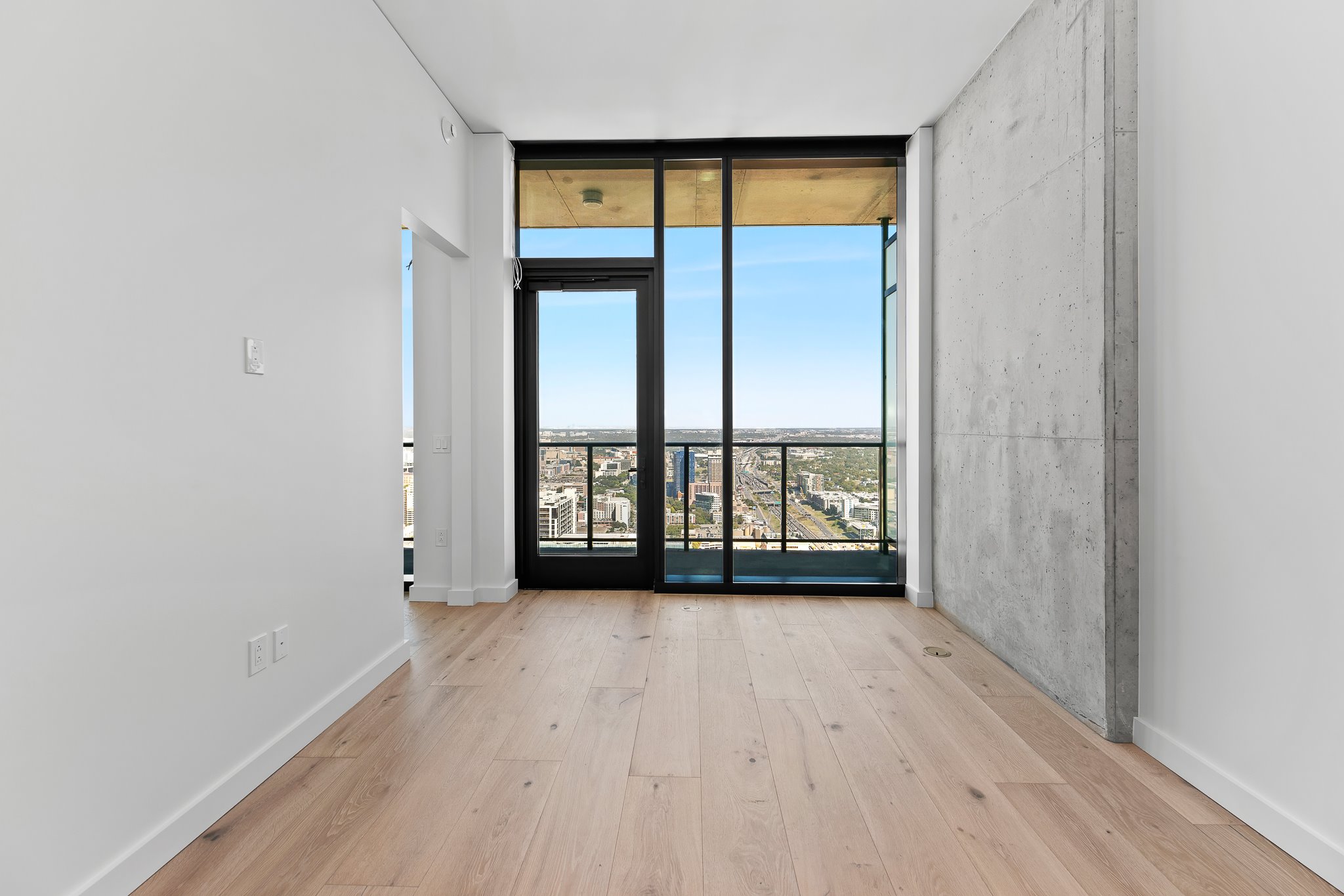 610 Davis Street, Unit 5206 Austin, TX 78701 - Photo 12 of 35 wooden floor in an empty room with a window